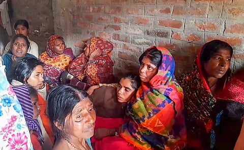 Family members mourn the death of a victim who died in a stampede at the New Delhi railway station that occurred late Saturday night.