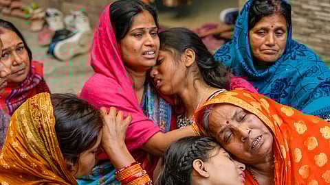 Relatives of 38-year-old Pinky Devi, who died in a stampede at the New Delhi Railway Station, mourn her death, at Sangam Vihar in New Delhi, Sunday, Feb. 16, 2025.