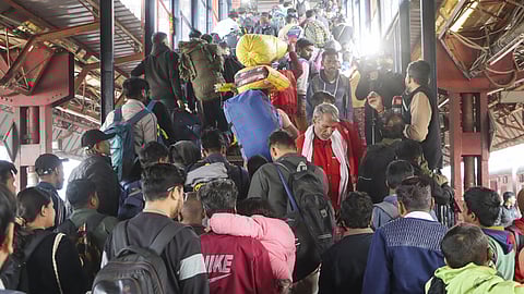 Passengers in a large number at the New Delhi railway station, Sunday, Feb. 16, 2025.