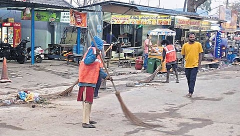 Sanitation workers sweep roads in Mulugu district. The  administration has deployed over 400 sanitation workers in Medaram village