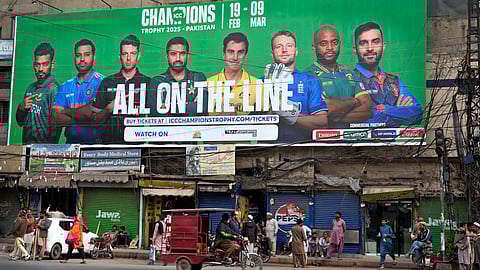 A billboard depicting portraits of the captains of participating teams in ICC Champions Trophy installed at a roadside, in Lahore