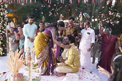 Gowri J S and Arjun S exchange garlands during their night wedding