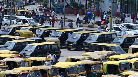 Taxis and auto rickshaws stand parked outside New Delhi Railway Station.