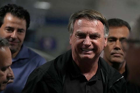 Protesters dressed as police escorting U.S. President Donald Trump and former president of Brazil Jair Bolsonaro demonstrate against Trump's announcement of 50% tariffs on Brazilian goods and against U.S. report that cited counterfeit product sales in Brazil, in Sao Paulo, Friday, July 18, 2025. 