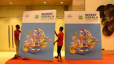 Workers arranging Invest Kerala boards at Lulu International Convention Centre in Bolgatty, Kochi
