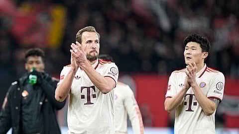 Bayern's Harry Kane and Bayern's Kim Min-jae, right, applaud supporters at the end of the German Bundesliga soccer match between Bayer Leverkusen and FC Bayern Munich at the BayArena in Leverkusen, Germany, Saturday, Feb. 15, 2025. 