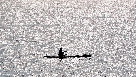 A fisherman sets out to the sea under the scorching midday sun at Vizhinjam in Thiruvananthapuram 