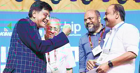 Union Commerce Minister Piyush Goyal gestures in appreciation at Leader of Opposition V D Satheesan after the latter’s speech during the Invest Kerala Global Summit in Kochi on Friday, while Chief Minister Pinarayi Vijayan and Industries Minister P Rajeeve look on.