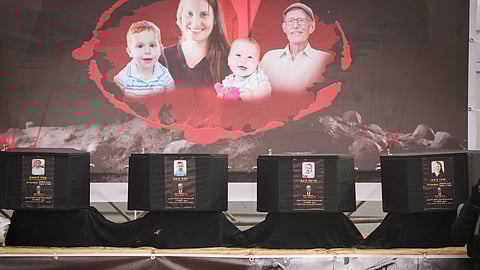 The coffins containing the bodies, from right to left, Shiri Bibas, her two children, Ariel and Kfir and Oded Lifshitz, who was 83 when he was abducted, are displayed on a stage in Khan Younis, southern Gaza Strip, Thursday, Feb. 20, 2025. 