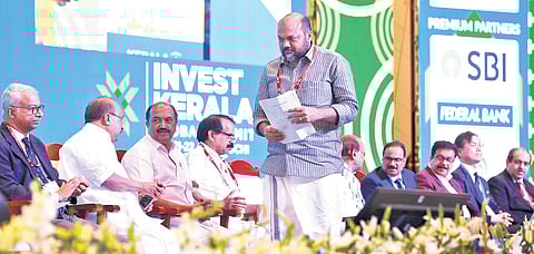 Industries Minister P Rajeeve moves to the podium to address the gathering at the valedictory function of the summit at Lulu International Convention Centre in Kochi on Saturday. T P Sooraj