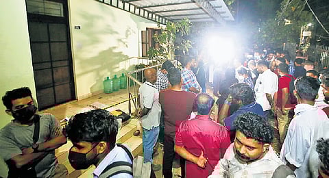 Residents gathered in front of the Kakkanad customs quarters.