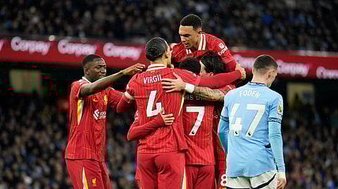 Liverpool's Mohamed Salah is congratulated after scoring his side's opening goal during the English Premier League football match between Manchester City and Liverpool.