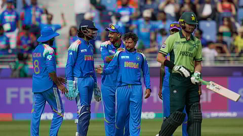 Kuldeep Yadav, second from right, celebrates with teammate the wicket of Pakistan's Shaheen Afridi , right, during the ICC Champions Trophy cricket match between India and Pakistan at Dubai International Cricket Stadium.