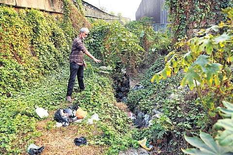 Shabeer points towards the polluted area in Eloor.