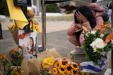 A woman mourns in a memorial for deceased hostages Shiri Bibas, her two children, at 'Hostages Square', where Israelis are gathering while waiting for the release of six hostages in Gaza, in Tel Aviv, Israel