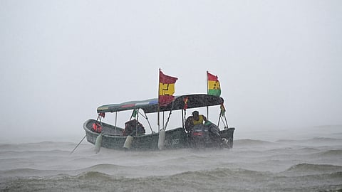A boat of indigenous Gunas sails under heavy rain and wind in the port of Carti, Guna Yala territory, Panama on 22 February 2025
