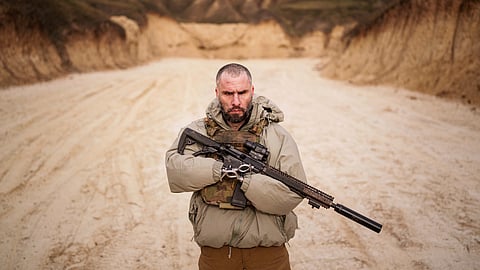 Andrii Rubliuk, a senior sergeant with a Ukrainian intelligence unit who lost both arms and a leg in combat, holds a rifle during military training near Kyiv, Ukraine, on Feb. 14, 2025.