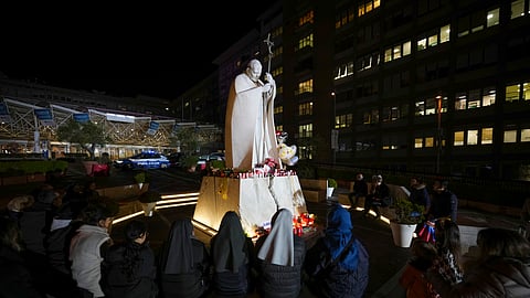 People pray for Pope Francis in front of the Agostino Gemelli Polyclinic, in Rome, Sunday, Feb. 23, 2025, where the Pontiff is hospitalized since Friday, Feb. 14