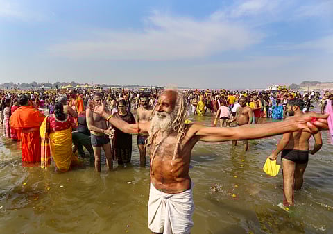 A sadhu takes a holy dip at the Sangam during the ongoing Maha Kumbh Mela 2025, ahead of the Maha Shivaratri festival in Prayagraj (Photo | PTI)