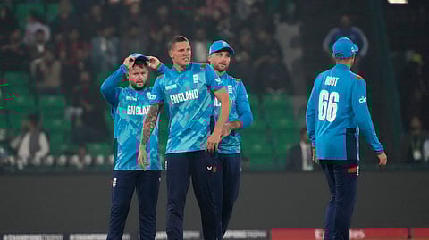 England's Brydon Carse, center, celebrates with teammates after taking the wicket of Australia's Alex Carey during the ICC Champions Trophy cricket match between Australia and England, in Lahore, Pakistan, Saturday, Feb. 22, 2025.