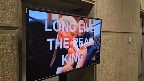 AI-generated video of US President Donald Trump kissing billionaire Elon Musk’s feet plays in the Department of Housing and Urban Development cafeteria on Feb. 24, 2025.