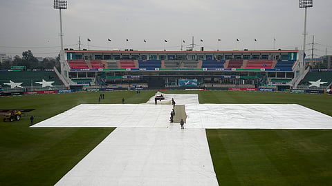 Groundsmen cover the pitch and field area due to low rain fall before start of the ICC Champions Trophy cricket match between Australia and South Africa, in Rawalpindi, Pakistan Tuesday, Feb. 25, 2025.