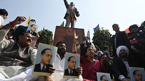 AAP MLAs, including LoP Atishi, who have been suspended from the Delhi Assembly for the day, hold protest in the Assembly premises in New Delhi on Tuesday.