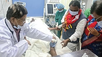 CM Majhi taking stock of the servitor’s health condition at the hospital.