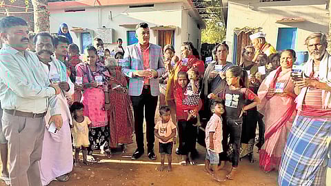 Vijayanagara Deputy Commissioner MS Divakara distributes VIP passes for Hampi Utsav among pourakarmikas in Hosapete on Thursday