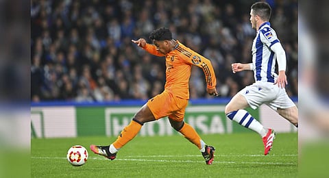 Real Madrid's Endrick, left, scores his side's opening goal during the Spanish Copa del Rey soccer match between Real Sociedad and Real Madrid at the Reale Arena in San Sebastian, Spain, Wednesday, Feb. 26, 2025. 