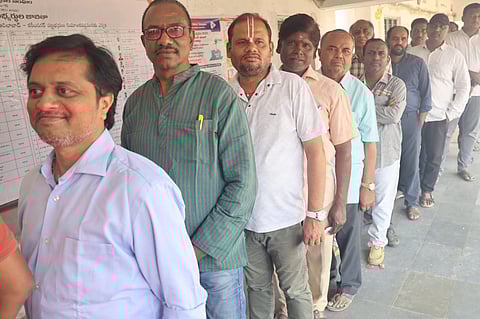 Voters wait in line at the Karimanagar Graduates  Constituency during Telangana Legislative Council elections. 
