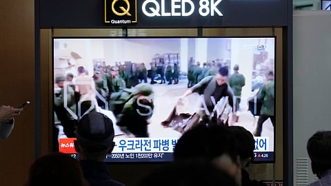 This image from Oct. 21, 2024, shows a TV screen at Seoul Railway Station in South Korea broadcasting an image of soldiers believed to be from North Korea standing in line to receive supplies from Russia.