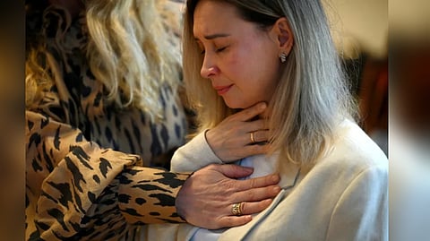 Psychotherapist Tetiana Moiseyeva (L) supports a woman attending a psychological training session at the Ukrainian Women's Club in Warsaw on January 30, 2025.