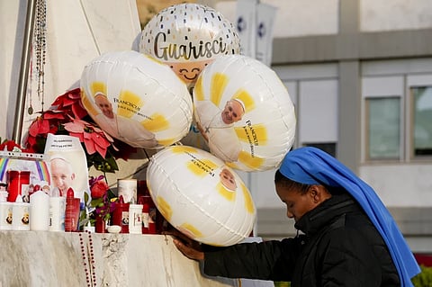 A nun prays for Pope Francis in front of the Agostino Gemelli Polyclinic, in Rome, Sunday, Feb. 23, 2025, where the Pontiff is hospitalized since Friday, Feb. 14.