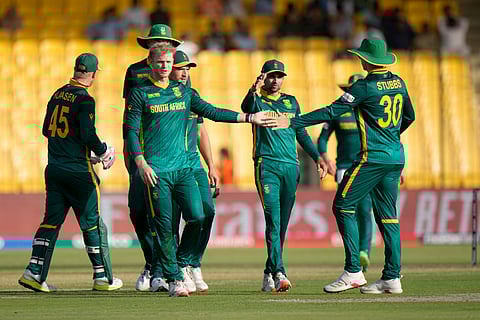 South Africa's Wiaan Mulder celebrates with teammates after taking a wicket during the ICC Champions Trophy match against England in Karachi (Photo | AP)