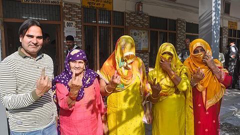Voters show their inked fingers after casting votes for municipal elections, in Sonipat.