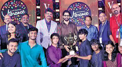 Actor Naga Chaitanya handing over the trophy to winners of Vibrance 2025 