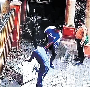 Representatives of the builder removing flex banners at HM Tambourine Apartments on Saturday