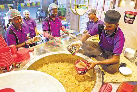 A worker seen packing haleem at a restuarant in Hyderabad on Sunday. A mini pot of haleem costs around Rs 300.