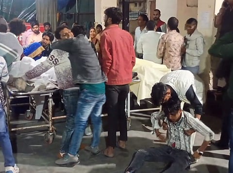 Relatives mourn near bodies of victims at a hospital after five people were killed following a collision between two bikes, in Agra district.