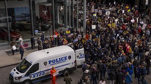 Demonstrators are arrested by NYPD officers during a protest against Elon Musk and Tesla outside of a Tesla showroom, Saturday, March 01, 2025 in New York.