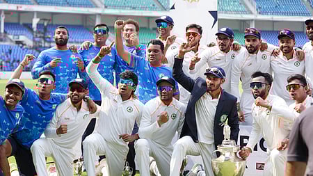 Vidarbha players pose with the trophy after winning the Ranji Trophy final cricket match against Kerala