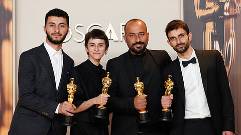 Basel Adra, from left, Rachel Szor, Hamdan Ballal, and Yuval Abraham, winners of the award for best documentary feature film for "No Other Land," pose in the press room at the Oscars on Sunday, March 2, 2025, at the Dolby Theatre in Los Angeles.