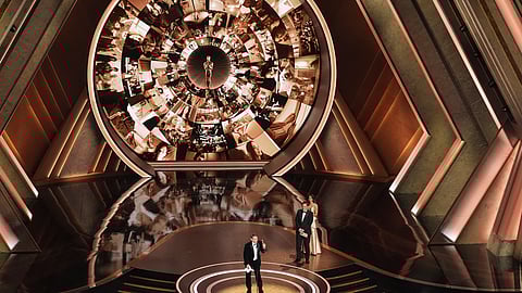 Sean Baker accepts the award for best director for "Anora" during the Oscars on Sunday, March 2, 2025, at the Dolby Theatre in Los Angeles. Quentin Tarantino look on from right.(AP Photo/Chris Pizzello)