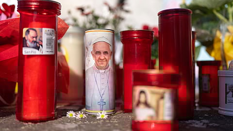 Candles left outside the Agostino Gemelli Polyclinic, in Rome, Monday, March 3, 2025, where Pope Francis has been hospitalized since Friday, Feb. 14. 