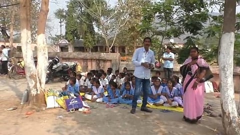 Students attending classes outside the school on Monday.