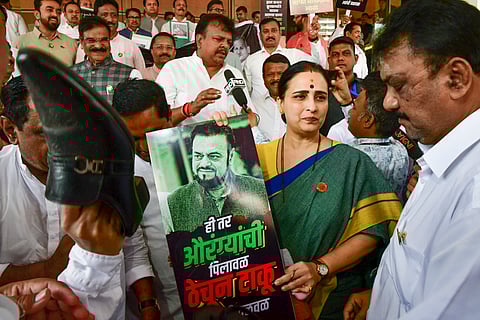 Members of the ruling Mahayuti stage a protest against Samajwadi Party MLA Abu Asim Azmi over his remarks about Mughal emperor Aurangzeb, during the Budget session of Maharashtra Assembly, in Mumbai.