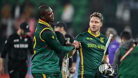 South Africa's David Miller (R) shakes hands with his teammate Lungi Ngidi at the end of the ICC Champions Trophy ODI semi-final cricket match between New Zealand and South Africa on March 5, 2025. 
