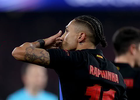 Barcelona's Raphinha celebrates scoring his team's first goal during the UEFA Champions League Round of 16 first leg football match between SL Benfica and FC Barcelona on March 5, 2025.