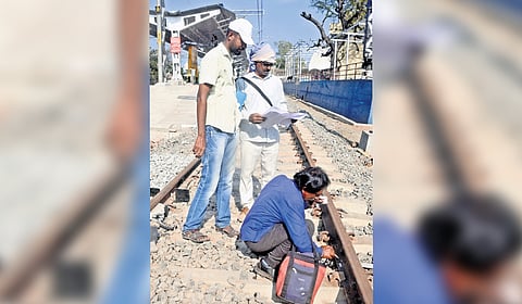 Railway staff seen marking the railway track at Park station 